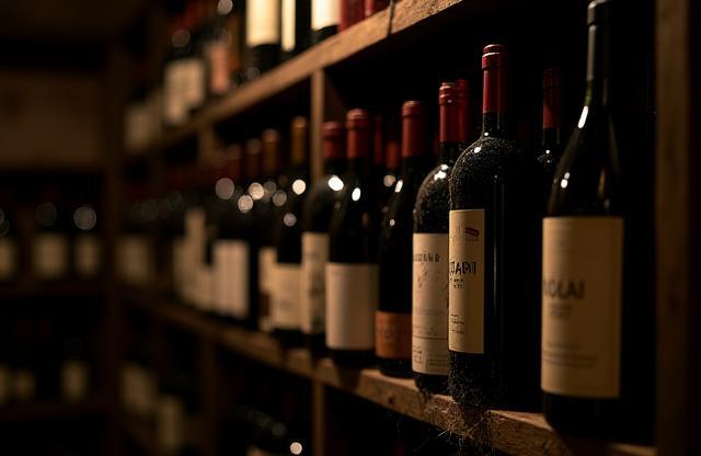 Collection of Italian wine bottles in a cellar.